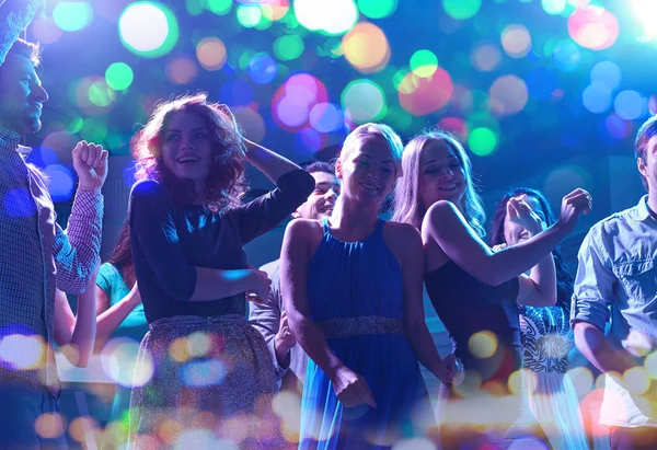 Group of happy friends dancing in night club — Stock Photo, Image