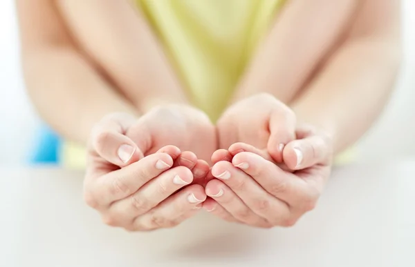 Close up of woman and girl with cupped hands — Stock Photo, Image