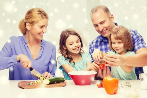 Onnellinen perhe, jossa kaksi lasta tekee päivällistä kotona — kuvapankkivalokuva