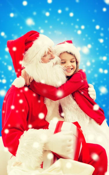 Smiling little girl with santa claus — Stock Photo, Image