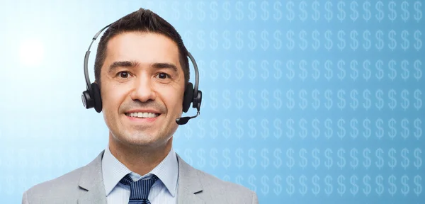 Businessman in headset over dollar currency symbol — Stock Photo, Image