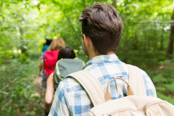 Close up of friends with backpacks hiking — Stock Photo, Image