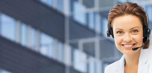 Helpline operator in headset over business center Stock Photo