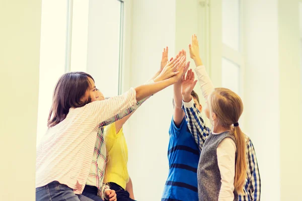 Group of school kids making high five gesture — Stock Photo, Image