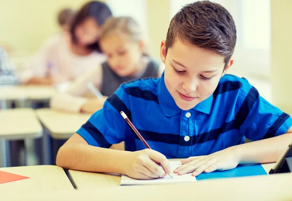 Groep van school-kids schrijven test in klas — Stockfoto