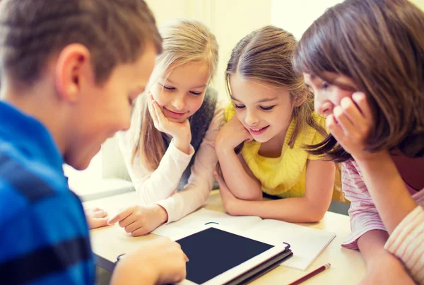 Group of school kids with tablet pc in classroom — Stock Photo, Image