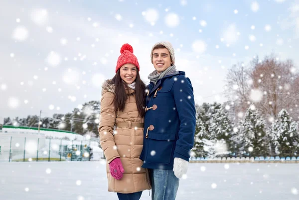 Happy couple ice skating on rink outdoors — Stock Photo, Image