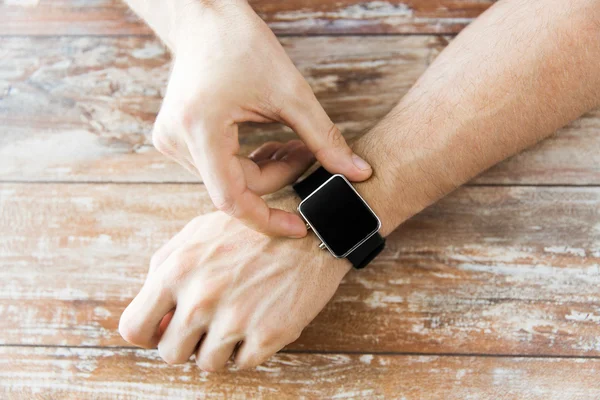 close up of male hands setting smart watch