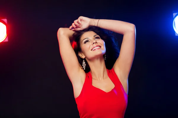 Beautiful sexy woman in red dancing at nightclub — Stock Photo, Image