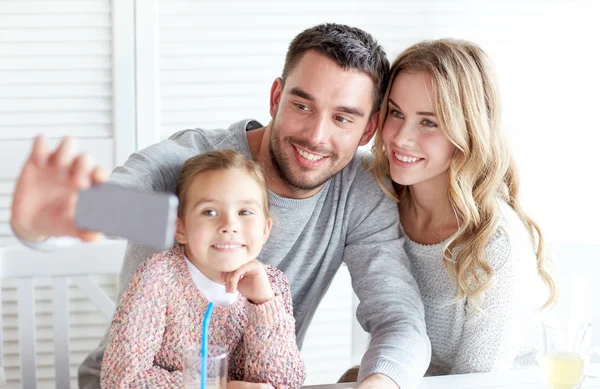 Happy family taking selfie at restaurant — Stock Photo, Image