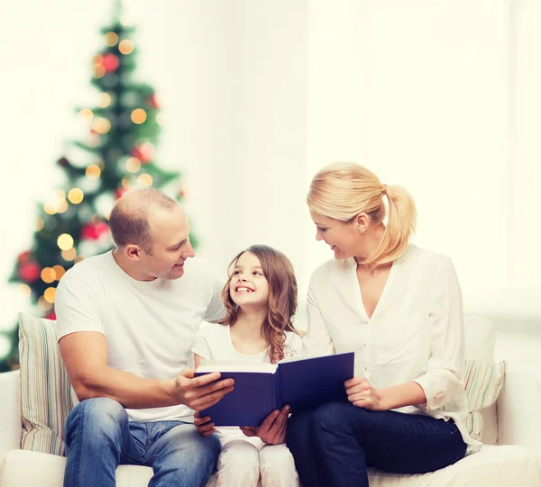 Familia feliz con libro en casa — Foto de Stock