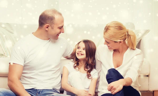 Parents and little girl sitting on floor at home — Stock Photo, Image