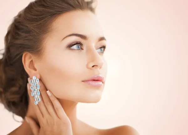 Kvinna som bär glänsande diamantörhängen — Stockfoto