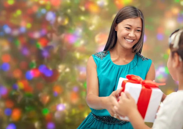 Happy mother giving christmas present to her child — Stockfoto