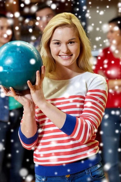 Happy young woman holding ball in bowling club — Stock Photo, Image