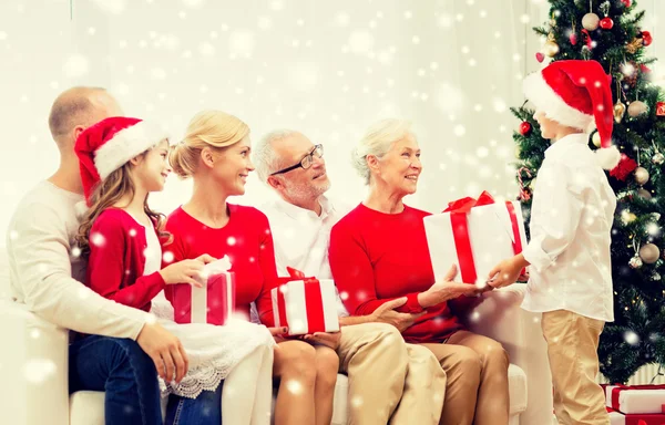 Smiling family with gifts at home — Stock Photo, Image