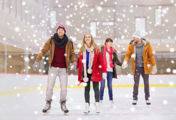 Happy friends on skating rink — Stock Photo, Image