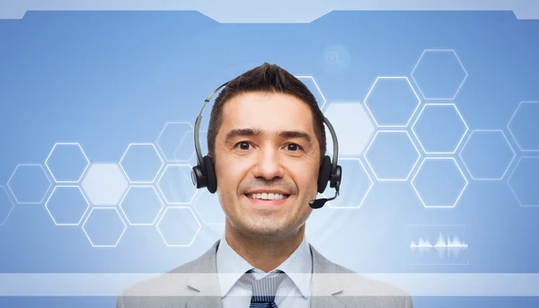 Hombre de negocios sonriente en auriculares sobre pantalla virtual —  Fotos de Stock