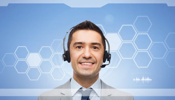 Smiling businessman in headset over virtual screen — Stock Photo, Image