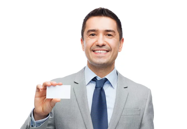 Smiling businessman in suit showing visiting card — Stok fotoğraf
