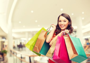 smiling young woman with shopping bags clipart