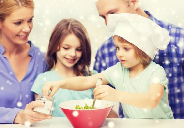 happy family with two kids making salad at home clipart