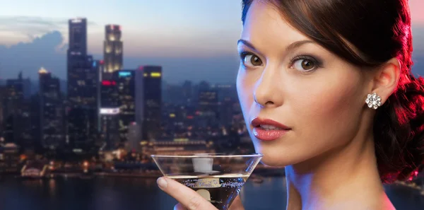 Woman holding cocktail over singapore night city — Stok fotoğraf