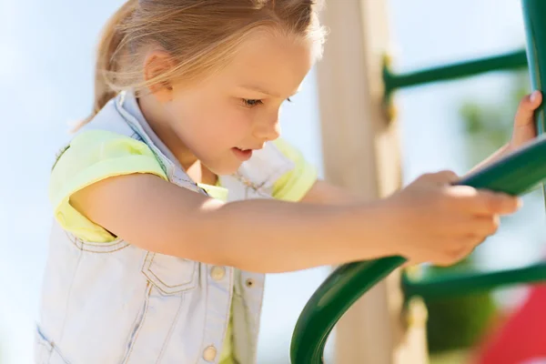 Happy little girl climbing on children playground — Stock Photo, Image