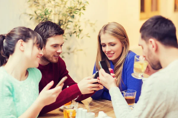 Freundeskreis mit Smartphones trifft sich im Café — Stockfoto