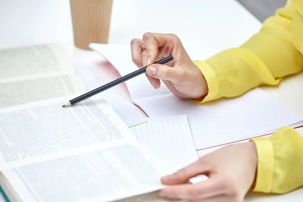 Close up of female hands with book and notebooks — 스톡 사진