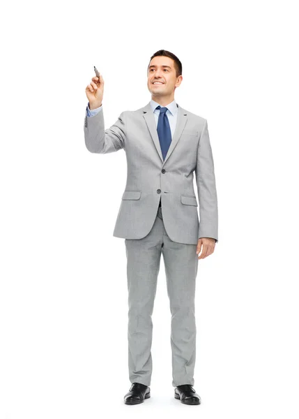 Happy businessman in suit writing something — Stock Photo, Image