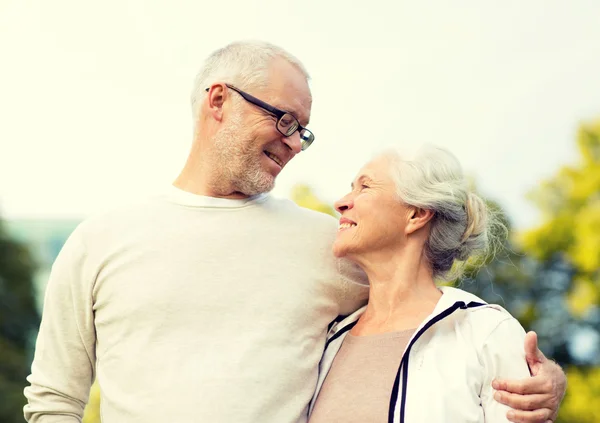 Senior couple hugging in city park — Stock Photo, Image