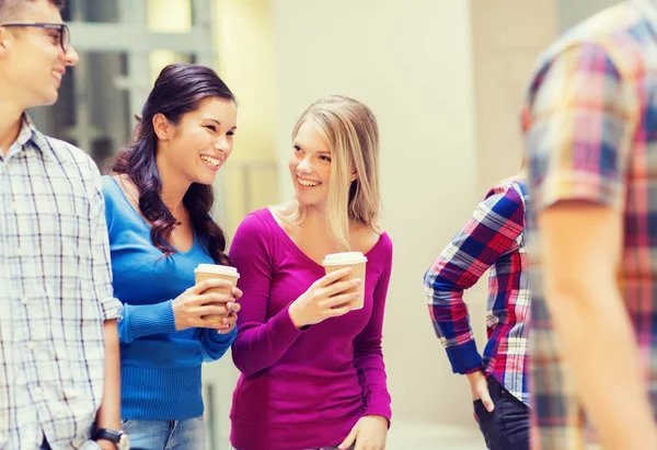 Group of smiling students with paper coffee cups — Stock Photo, Image