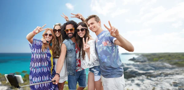 Amici hippie con smartphone su bastone selfie — Foto Stock