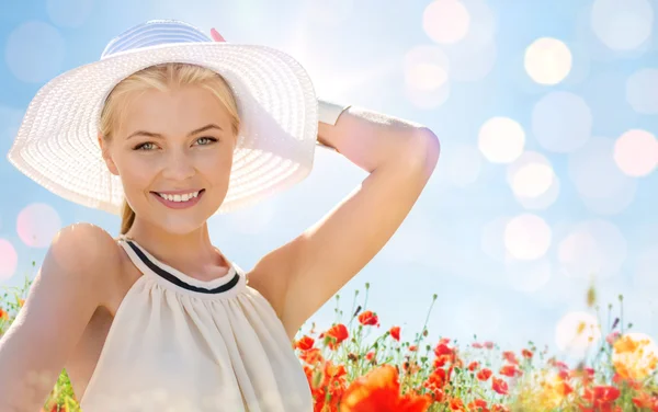 Gülümseyen genç kadın haşhaş sahada hasır şapkalı — Stok fotoğraf