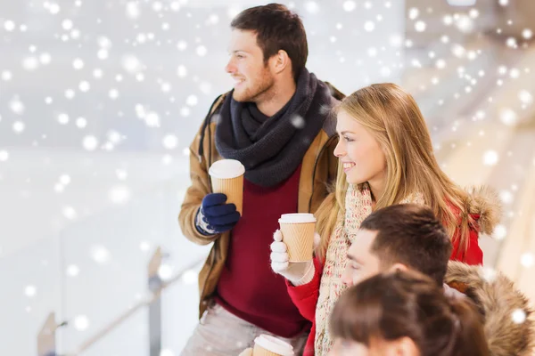 Glückliche Freunde mit Kaffeetassen auf der Eisbahn — Stockfoto