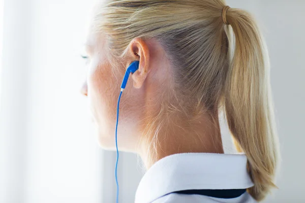 Close up of woman in earphones at home — Foto de Stock