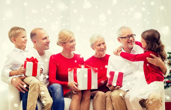 Smiling family with gifts at home — Stock Photo, Image