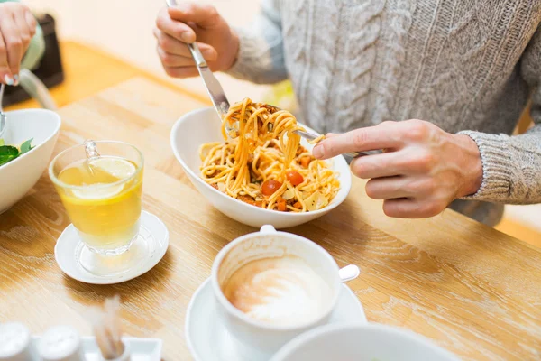 Close up man eating pasta for dinner at restaurant — Stok fotoğraf