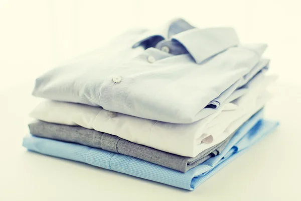 Close up of ironed and folded shirts on table — Stock Photo, Image