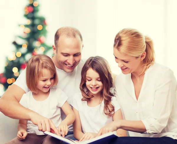 Familia feliz con libro en casa — Foto de Stock