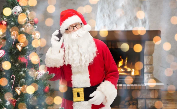 Santa claus with smartphone and christmas tree — Stock Photo, Image