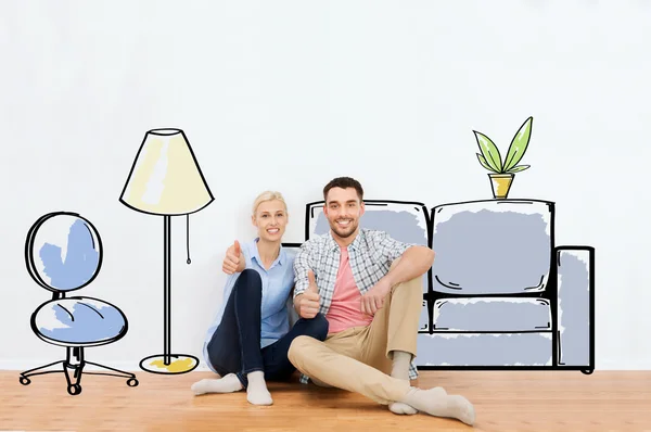Felice coppia mostrando pollici in su a nuova casa — Foto Stock