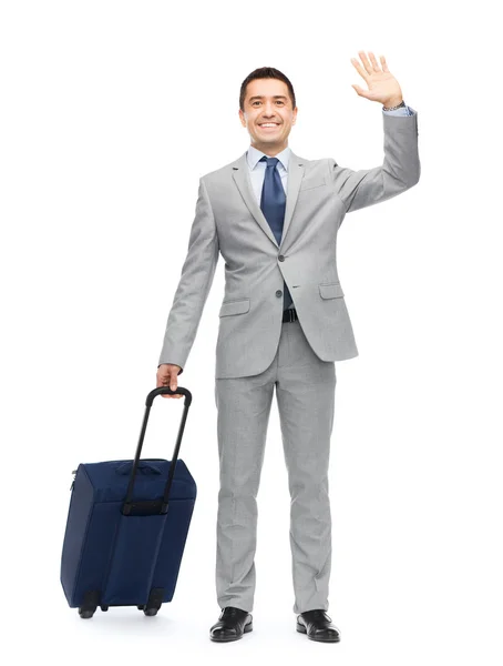 Hombre de negocios feliz en traje con bolsa de viaje —  Fotos de Stock