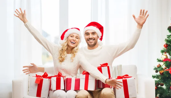 Happy couple at home with christmas gift boxes Stock Image