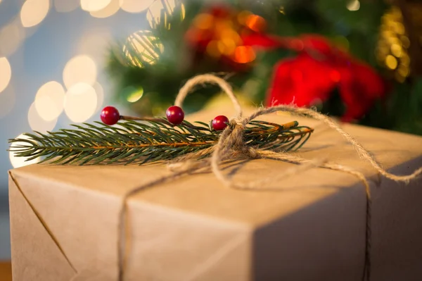 Close up of christmas gift with fir brunch — Stock Photo, Image