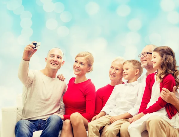 Smiling family with camera — Stock Photo, Image