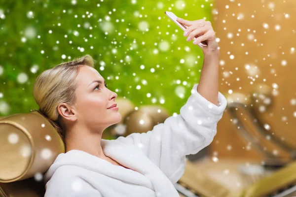 Woman taking selfie with smartphone  at spa — Stockfoto