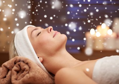 close up of smiling young woman lying in spa salon clipart