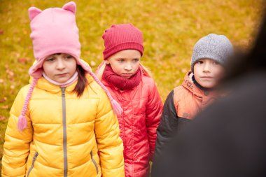 sad kids being blamed for misbehavior outdoors clipart